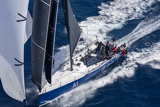 An aerial shot of a yacht racing.