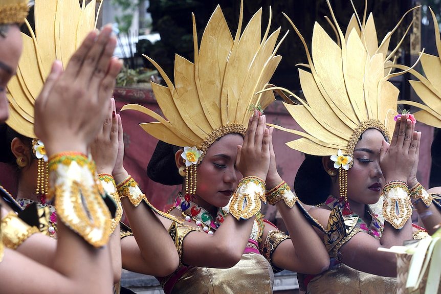 在文化游行期间，女舞者在表演前祈祷。