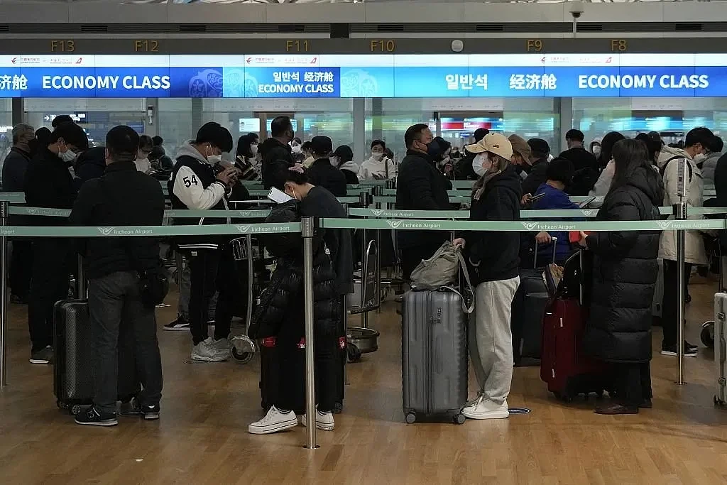 当地时间2023年1月10日，韩国仁川国际机场，乘客排队等待登机前往中国。图源：人民视觉