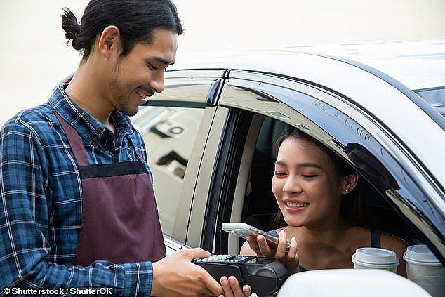 Young consumers have embraced tap-and-go payments as society increasingly goes 'cashless' (stock image)