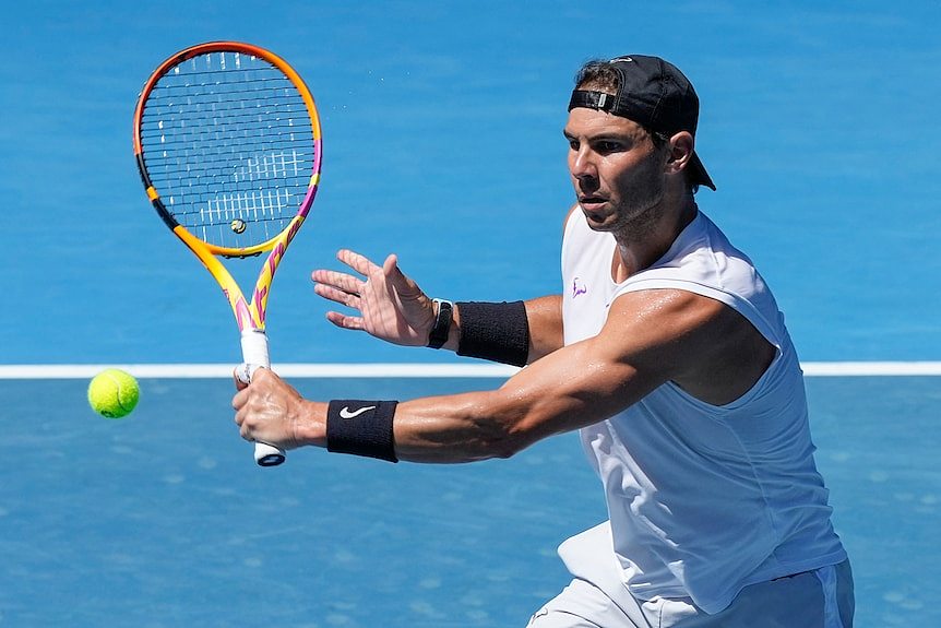 Spain's Rafael Nadal on a tennis court hitting a tennis ball with a tennis racket