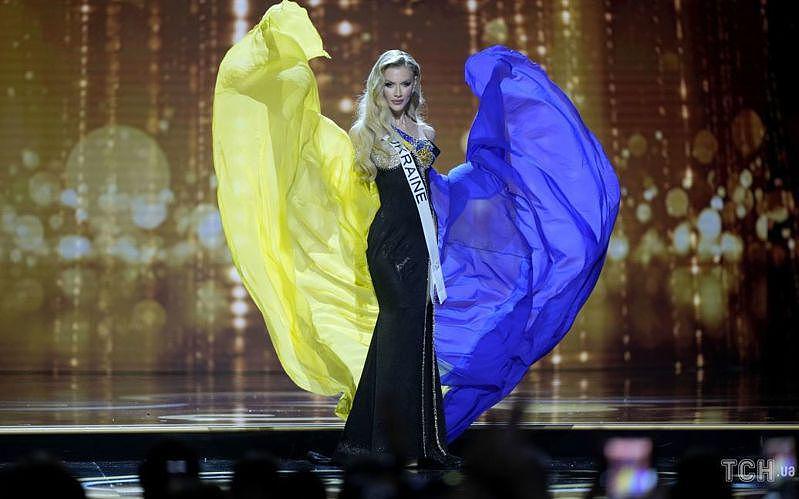 乌克兰小姐阿帕纳申科穿着黑色晚礼服，并披着乌克兰国旗颜色的斗篷。（取材自Inst...