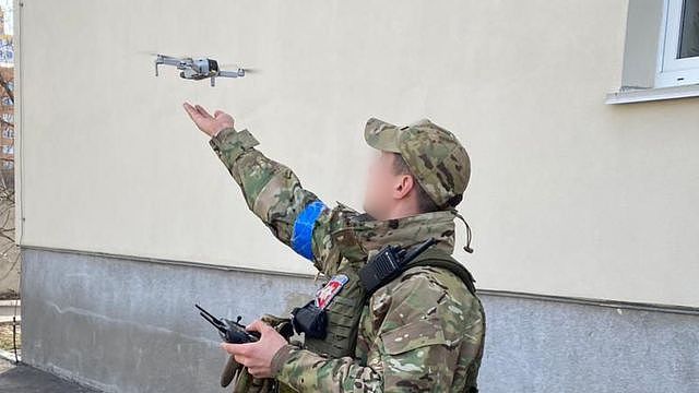 A Ukrainian soldier uses a small consumer drone