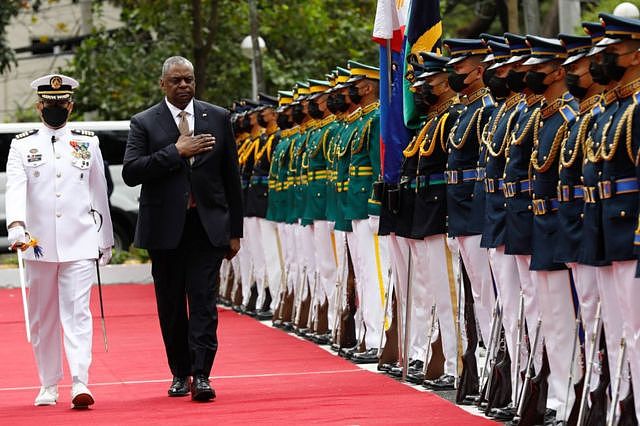 United States Defense Secretary Lloyd Austin (R) walks past military guards during arrival honors at the Department of National Defense in Camp Aguinaldo military camp on February 2, 2023 in Quezon City, Manila, Philippines.