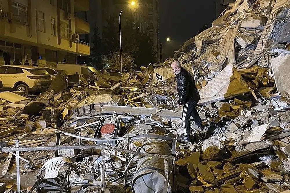 一名男子在土耳其南部迪亚巴克尔搜索倒塌的建筑物。 AP