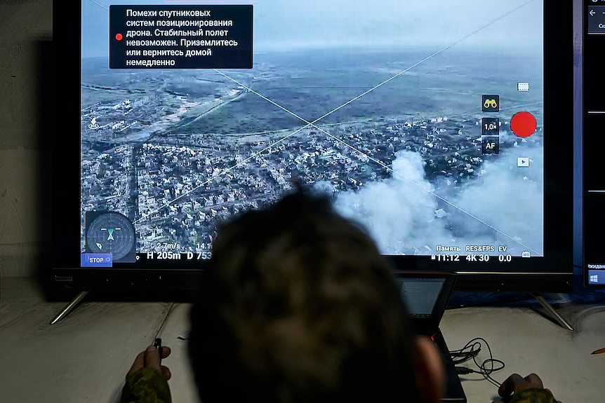 A Ukrainian soldier watches a drone feed from an underground command centre.