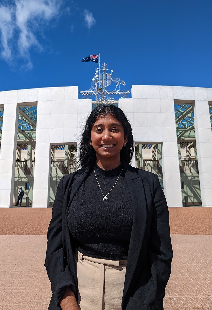 Tish Sivagnanan stands out the front of Parliament House in Canberra.