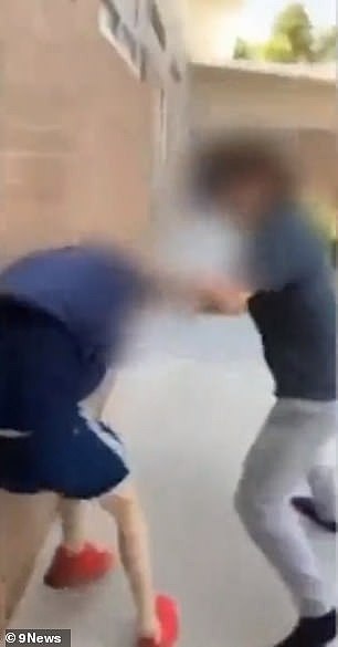The boy is seen chasing down and punching another student