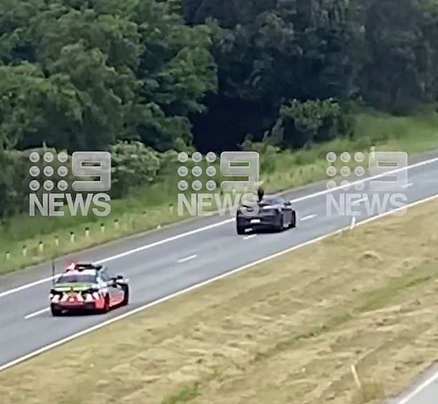 A bizarre chase unfolded on the M1 motorway near the Tweed region, with police chasing a Mercedes SUV that had a person on the roof