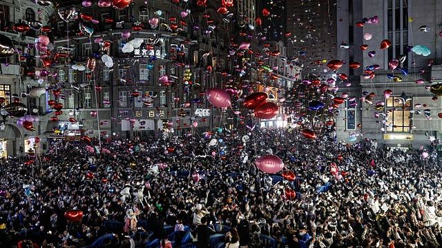 Revellers release balloons to celebrate the New Year on Jianghan Road, Wuhan on December 31, 2022