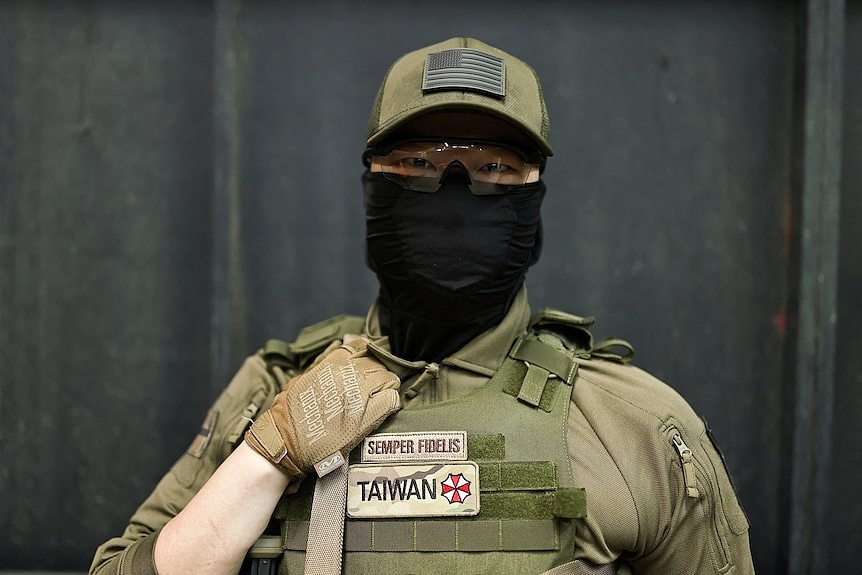 Tech journalist Alan Chen poses for a photograph during a break at an airsoft gun shooting lesson.