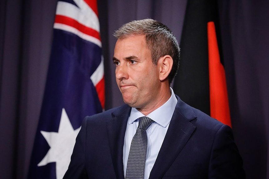 Jim Chalmers with a serious expression on his face at a press conference at Parliament House