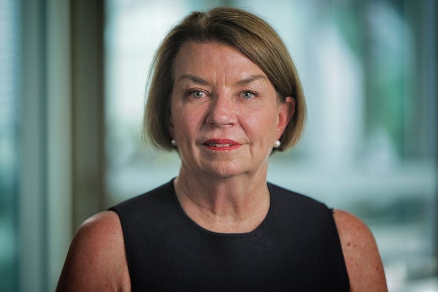 Woman with short hair wearing a dress. 