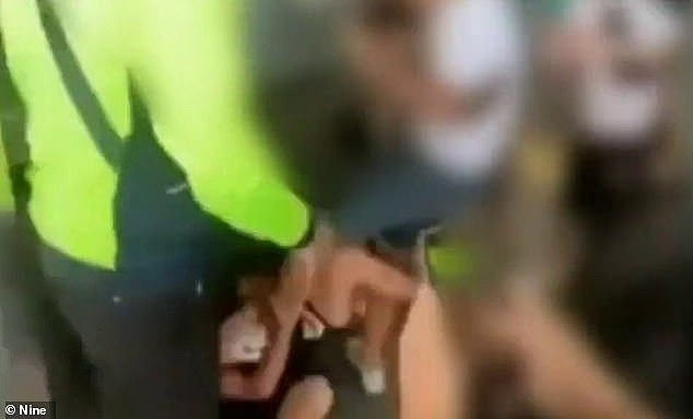 The victim is cornered and repeatedly punched, kicked and stomped on by more than half a dozen teens