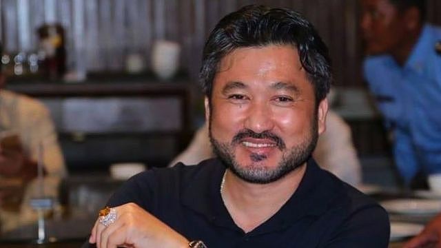 man with goatee sitting in restaurant