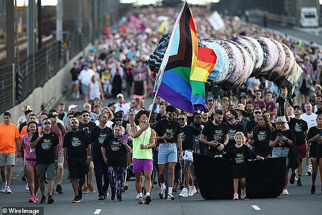 The Pride flag is waved as people march across the Sydney Harbour Bridge during World Pride celebrations last month
