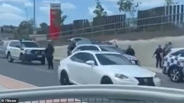 Police were alerted and they tracked the Landcruiser to nearby Quinns Hill Rd where heavily-armed officers pulled the car over and found two men and a woman inside (pictured)