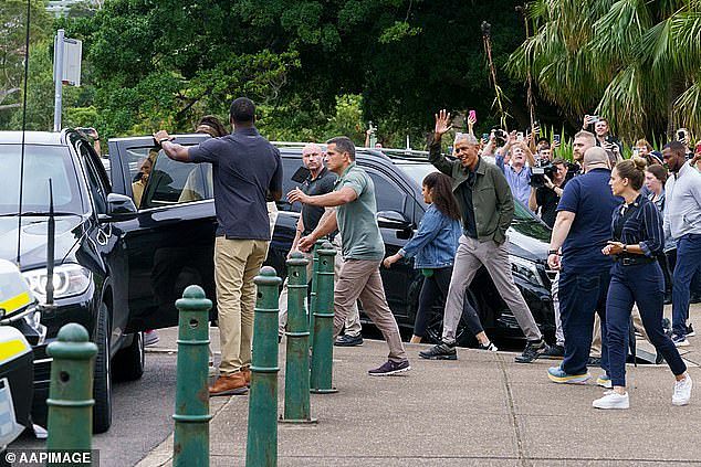 Former US President Barack Obama is pictured surrounded by Secret Service agents in Sydney