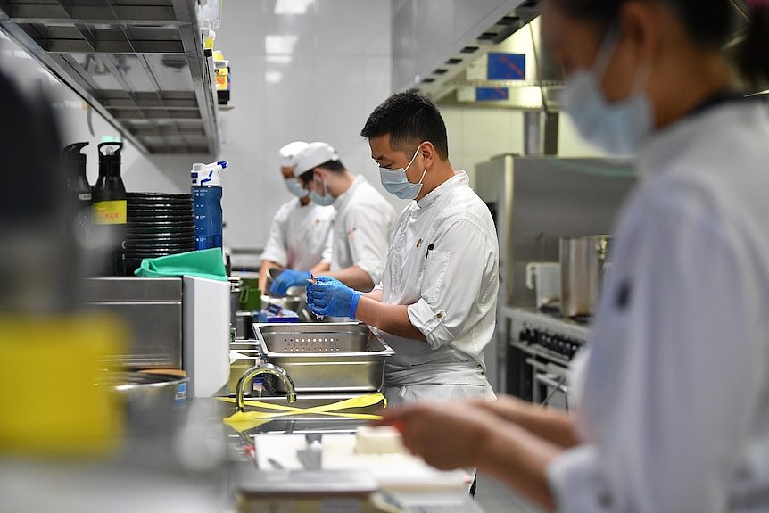 Workers preparing food in a restaurant