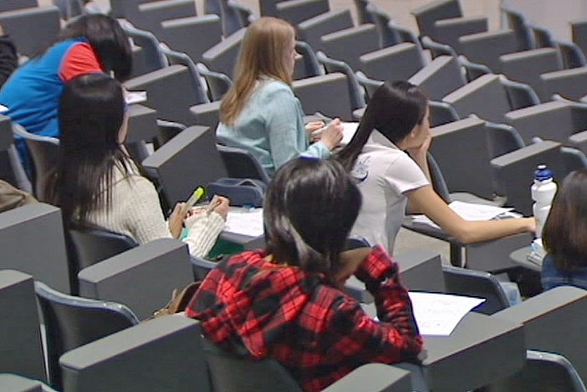 Students sitting in lecture hall.