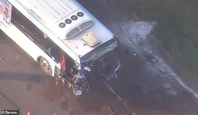 A bus driver was trapped inside the wreckage after a collision with a garbage truck (pictured)