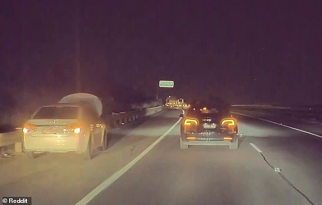 The clever video was sped up to show what was at the front of the line - a white car had broken down and was pulled over with its hazard lights on and the bonnet up