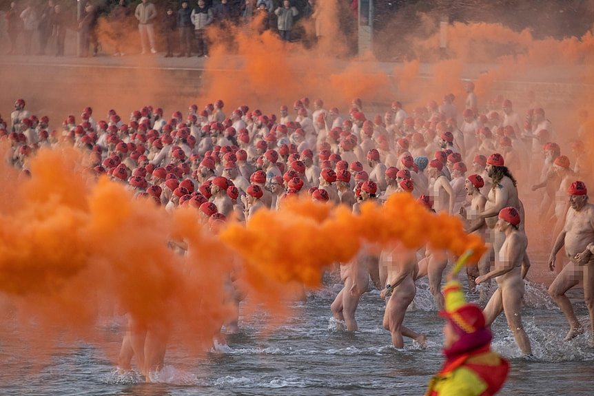 People run into the water, naked.