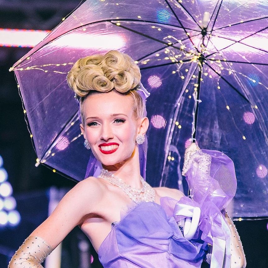 woman holding umbrella smiling