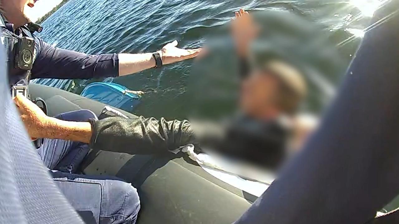 Police have released video of a daring rescue near a popular dolphin watching spot after a man was found clinging to a sunken boat. Picture: Queensland Police