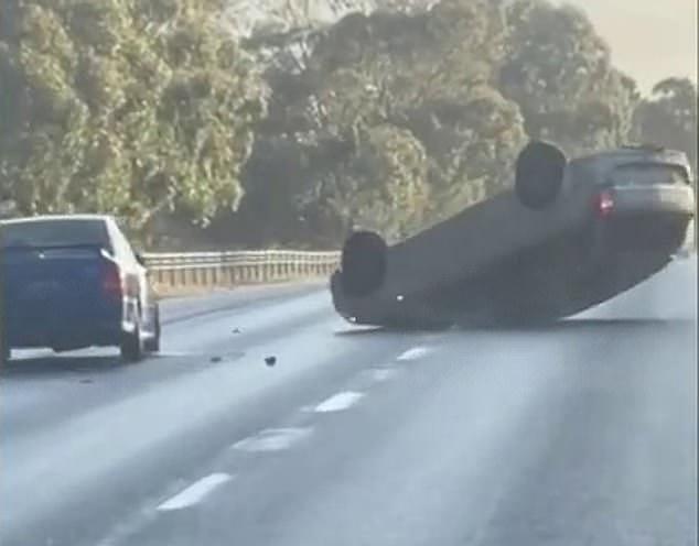 The Holden Astra was seen driving erratically behind a sedan before the Astra attempted to ram the car in front, incidentally mounting and flipping over before the driver exited the ruins with a knife