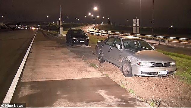 Two alleged drink drivers were arrested in Adelaide after a silver Mitsubishi (right) crashed into the back of a police car while officers were breath testing the driver of a black Jeep (left)