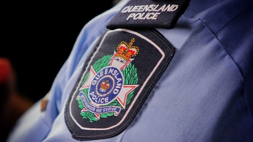 The Queensland Police Service insignia on the sleeve of a shirt.