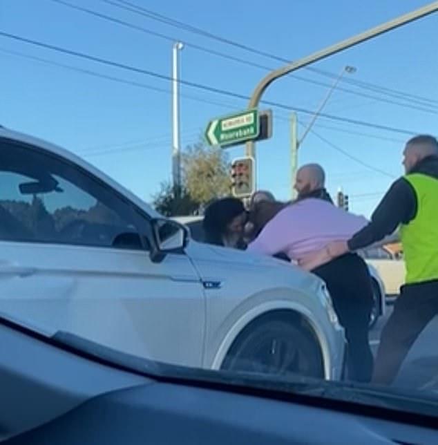 Local authorities have launched an investigation into the circumstances surrounding the scuffle (pictured, the woman loses her headscarf during the road rage clash)