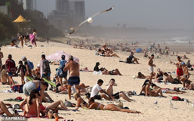 Queensland is currently working towards a net zero emission goal by 2050 and has an 80 per cent renewable energy target by 2035 (pictured, Queenslanders cool off in Surfers Paradise)