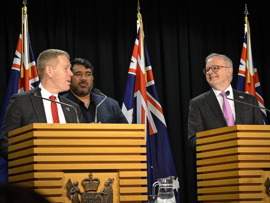 Chris Hipkins and Anthony Albanese standing at podiums at a press conference. 