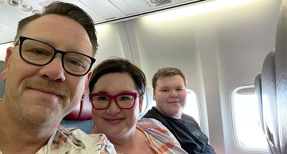 Jason Wilson on a Qantas plane with his partner and son. 