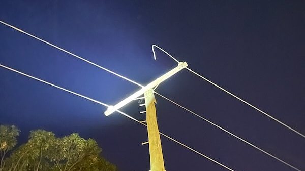 A power police with three wires, one of which has been cut.