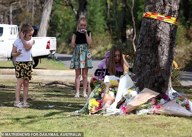 Buxton locals are seen leaving flowers at the scene of the crash that killed five students