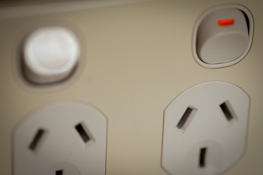 A close-up of a power point, one switch on, one switch off