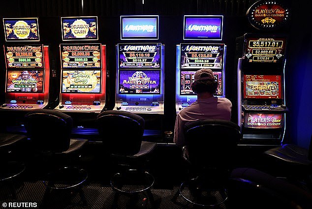 NSW gamblers lost $4.6billion on the pokies last year (pictured, gambler playing the pokies)