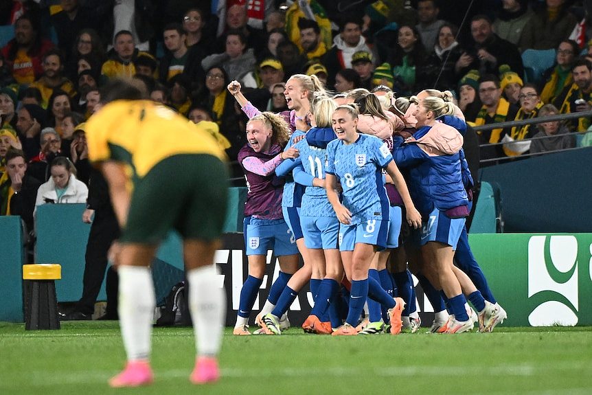 England celebrates as Sam Kerr looks on