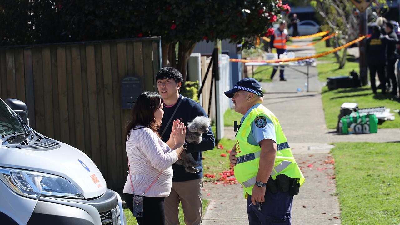 Neighbours are seen outside the exclusion zone. Picture: NCA Newswire/ Nicholas Eager