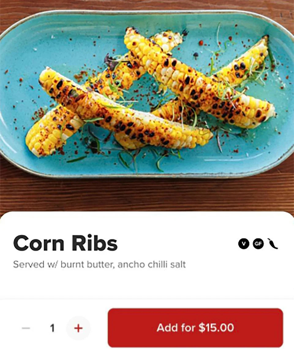 The restaurant's corn ribs showing four corn slivers on blue plate.