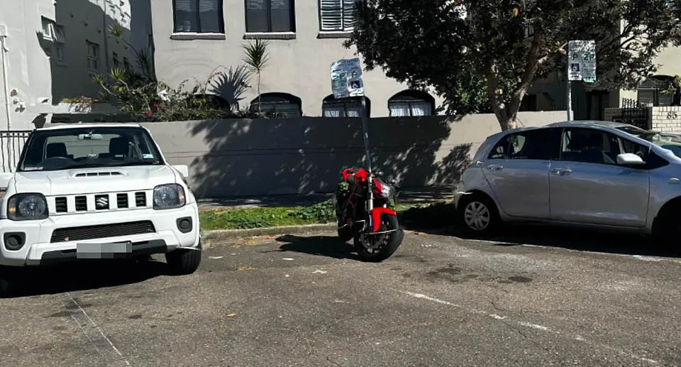 A photo of a motorbike taking up a car space on Roscoe Street in Bondi.
