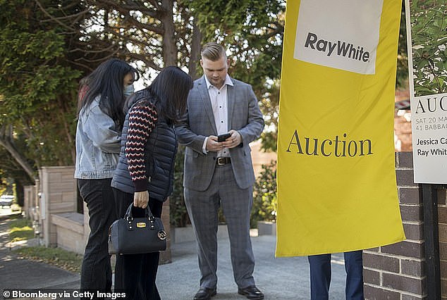 Australia's cost of living crisis is now so bad an overwhelming majority of consumers regard high inflation as a 'very big problem' - as a record number of borrowers sell after three years (pictured is a Sydney auction)