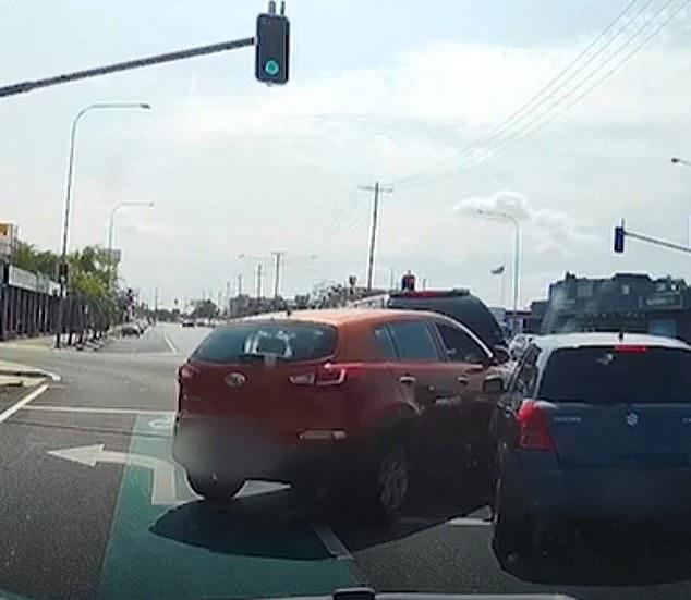 The irate driver of the Kia was seen to drive the vehicle straight into the grey Suzuki (pictured) and collide with the black 4WD just as the traffic lights at the intersection turned green