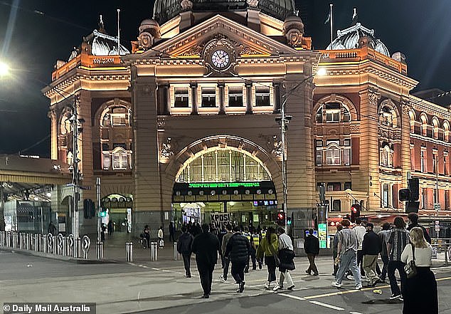 Daily Mail Australia spotted the group staging a protest on the steps of the city's iconic Flinders Street Station early on Saturday morning behind a banner which read 'Expose Jewish Power'