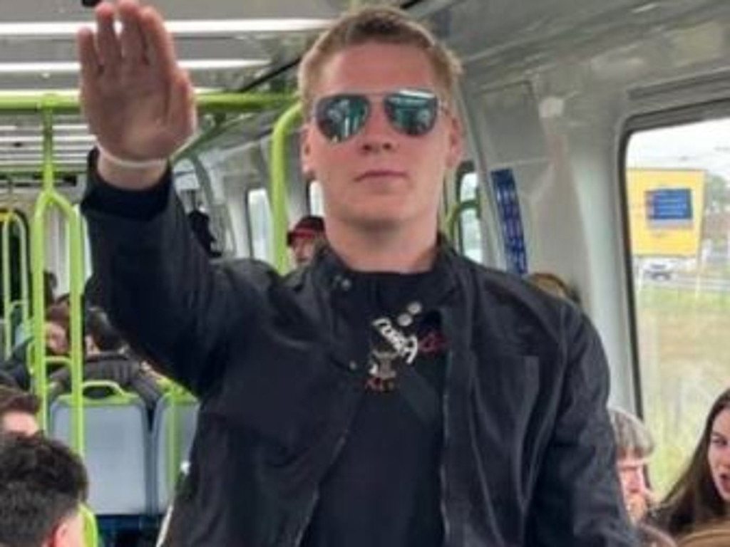 A known neo-Nazi has been captured performing the near-banned salute onboard a busy Melbourne train. Picture: supplied