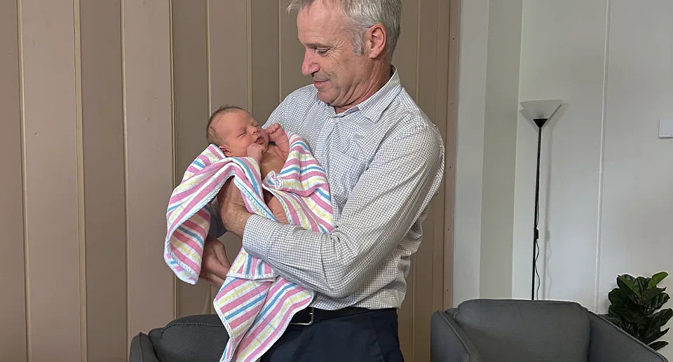 Professor Professor Robert Gilchrist holding baby Bonnie. 