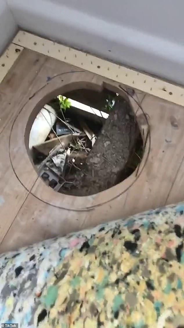 A renter in Melbourne was stunned to find a gaping hole (pictured) in the  floor of the property with several building materials and other rubbish stashed below